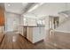 Open concept kitchen with an island and stainless steel appliances, flowing into a spacious living area at 1622 W 67Th Ave, Denver, CO 80221