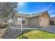 Charming home featuring a stone facade and a well-manicured front lawn at 7511 S Sicily Way, Aurora, CO 80016