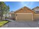 Exterior view showing the home's attached garage and well-kept lawn at 7511 S Sicily Way, Aurora, CO 80016