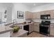 Well-lit kitchen with modern appliances, ample counter space, and stylish backsplash at 9599 Cedarhurst Ln # A, Highlands Ranch, CO 80129