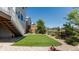 Well-maintained backyard featuring artificial turf, a small wooden deck with stairs, and low-maintenance landscaping at 18875 W 93Rd Ave, Arvada, CO 80007