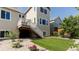 Well-maintained backyard featuring artificial turf, a small wooden deck with stairs, and low-maintenance landscaping at 18875 W 93Rd Ave, Arvada, CO 80007