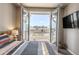 Bedroom view through French doors to balcony and neighborhood at 18875 W 93Rd Ave, Arvada, CO 80007