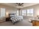 Spacious bedroom filled with natural light, featuring three large windows and a comfortable bed with stylish patterned bedding at 18875 W 93Rd Ave, Arvada, CO 80007