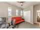 Bedroom featuring a bright red futon and multiple windows for natural light, also showing an attached bathroom at 18875 W 93Rd Ave, Arvada, CO 80007
