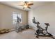 Bedroom featuring exercise equipment, a ceiling fan, and a window for natural light at 18875 W 93Rd Ave, Arvada, CO 80007