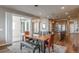 Dining area featuring hardwood floors, access to the patio, and a seamless flow into the kitchen at 18875 W 93Rd Ave, Arvada, CO 80007