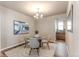 Elegant dining room featuring a modern chandelier, neutral color palette, and ample natural light at 18875 W 93Rd Ave, Arvada, CO 80007