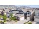 Two-story home with stone accents, a two-car garage, well-maintained landscaping, and mountain views at 18875 W 93Rd Ave, Arvada, CO 80007