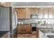 Modern kitchen with stainless steel appliances, granite counters, and ample cabinet space at 18875 W 93Rd Ave, Arvada, CO 80007