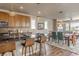 Open concept kitchen featuring a large island, modern backsplash, and a seamless transition into the dining area at 18875 W 93Rd Ave, Arvada, CO 80007