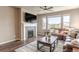 Inviting living room with a fireplace, plush sofa, and a ceiling fan at 18875 W 93Rd Ave, Arvada, CO 80007