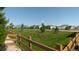 A community park and green space with manicured grass and mature trees in a well maintained neighborhood at 18875 W 93Rd Ave, Arvada, CO 80007