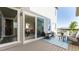 Outdoor patio with comfortable seating and a dining table visible through sliding glass doors at 18875 W 93Rd Ave, Arvada, CO 80007