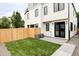 Backyard with green grass, wood fence, and a patio at 1541 Glencoe St, Denver, CO 80220
