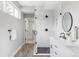 Elegant bathroom with glass-enclosed shower, tile floors, and modern fixtures at 1541 Glencoe St, Denver, CO 80220