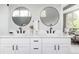 Modern bathroom vanity with double sinks, round mirrors, and sleek hardware at 1541 Glencoe St, Denver, CO 80220