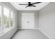 Bright bedroom featuring a modern ceiling fan, a large window, and double doors at 1541 Glencoe St, Denver, CO 80220