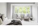 Bright bedroom with comfortable seating area, lots of light, neutral colors at 1541 Glencoe St, Denver, CO 80220