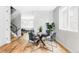 Modern dining area with glass table, stylish chairs, and hardwood floors at 1541 Glencoe St, Denver, CO 80220