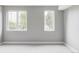 Bright, empty room with neutral carpet, fresh paint, and dual windows at 1541 Glencoe St, Denver, CO 80220