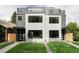 Exterior of modern townhomes with clean landscaping and a green lawn at 1541 Glencoe St, Denver, CO 80220