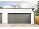 Large gray garage door with modern design on a sunny day at 1541 Glencoe St, Denver, CO 80220