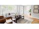 Bright, stylish living room with large windows, hardwood floors, and modern furnishings at 1541 Glencoe St, Denver, CO 80220