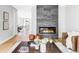 Open-concept living room with a modern fireplace, hardwood floors, and stylish decor at 1541 Glencoe St, Denver, CO 80220