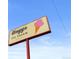 Charming sign of Nuggs Ice Cream featuring classic design and playful colors against a blue sky at 1541 Glencoe St, Denver, CO 80220