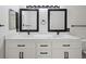 Modern bathroom features dual sinks, white cabinets, and black hardware at 3855 Canyon Ranch Rd # 104, Highlands Ranch, CO 80126