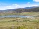 This aerial view shows a neighborhood and a beautiful lake at 3187 S Quaker St, Morrison, CO 80465