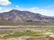 Aerial view showcasing the open space, mountains, and highway at 3187 S Quaker St, Morrison, CO 80465