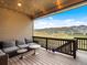Relax on this covered deck with outdoor seating and enjoy breathtaking mountain and neighborhood views at 3187 S Quaker St, Morrison, CO 80465