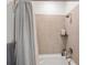 This bathroom features a tub with shower, tile surround, and shower curtain at 3187 S Quaker St, Morrison, CO 80465