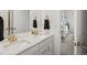 This bathroom features double sinks, a large mirror, and a view into a bedroom at 3187 S Quaker St, Morrison, CO 80465