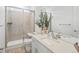 Modern bathroom with a glass-enclosed shower, vanity with sink, and neutral color scheme at 3187 S Quaker St, Morrison, CO 80465