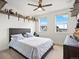 Comfortable bedroom with a plush bed, playful decor, and lots of natural light at 3187 S Quaker St, Morrison, CO 80465