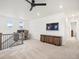 Spacious bonus room with a modern ceiling fan and a wall-mounted television for entertainment at 3187 S Quaker St, Morrison, CO 80465