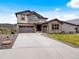 Charming two-story home with stone accents, gray garage, and a spacious driveway at 3187 S Quaker St, Morrison, CO 80465