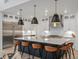 Contemporary kitchen with island seating, stainless appliances, and ample storage at 3187 S Quaker St, Morrison, CO 80465
