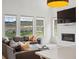 Open living room with comfortable seating, fireplace, and large windows at 3187 S Quaker St, Morrison, CO 80465