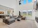 Spacious living room with high ceilings, large windows, comfortable seating, and a fireplace at 3187 S Quaker St, Morrison, CO 80465