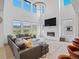 Bright living room with soaring ceilings, modern fireplace, and scenic views at 3187 S Quaker St, Morrison, CO 80465