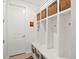 Well-organized mudroom featuring built-in shelving, hooks, bench seating, and storage baskets at 3187 S Quaker St, Morrison, CO 80465