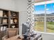 Inviting home office with built-in shelving and a large window framing picturesque mountain views at 3187 S Quaker St, Morrison, CO 80465