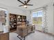 Home office with a large wooden desk, built-in bookshelves, and a view of the mountains at 3187 S Quaker St, Morrison, CO 80465