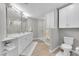 Modern bathroom with double sink vanity and a glass enclosed shower at 1303 S Danube Way # 104, Aurora, CO 80017