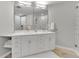 Modern bathroom with a double sink vanity and a glass enclosed shower at 1303 S Danube Way # 104, Aurora, CO 80017