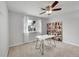 Bright bedroom featuring a ceiling fan, large window, and neutral décor at 1303 S Danube Way # 104, Aurora, CO 80017